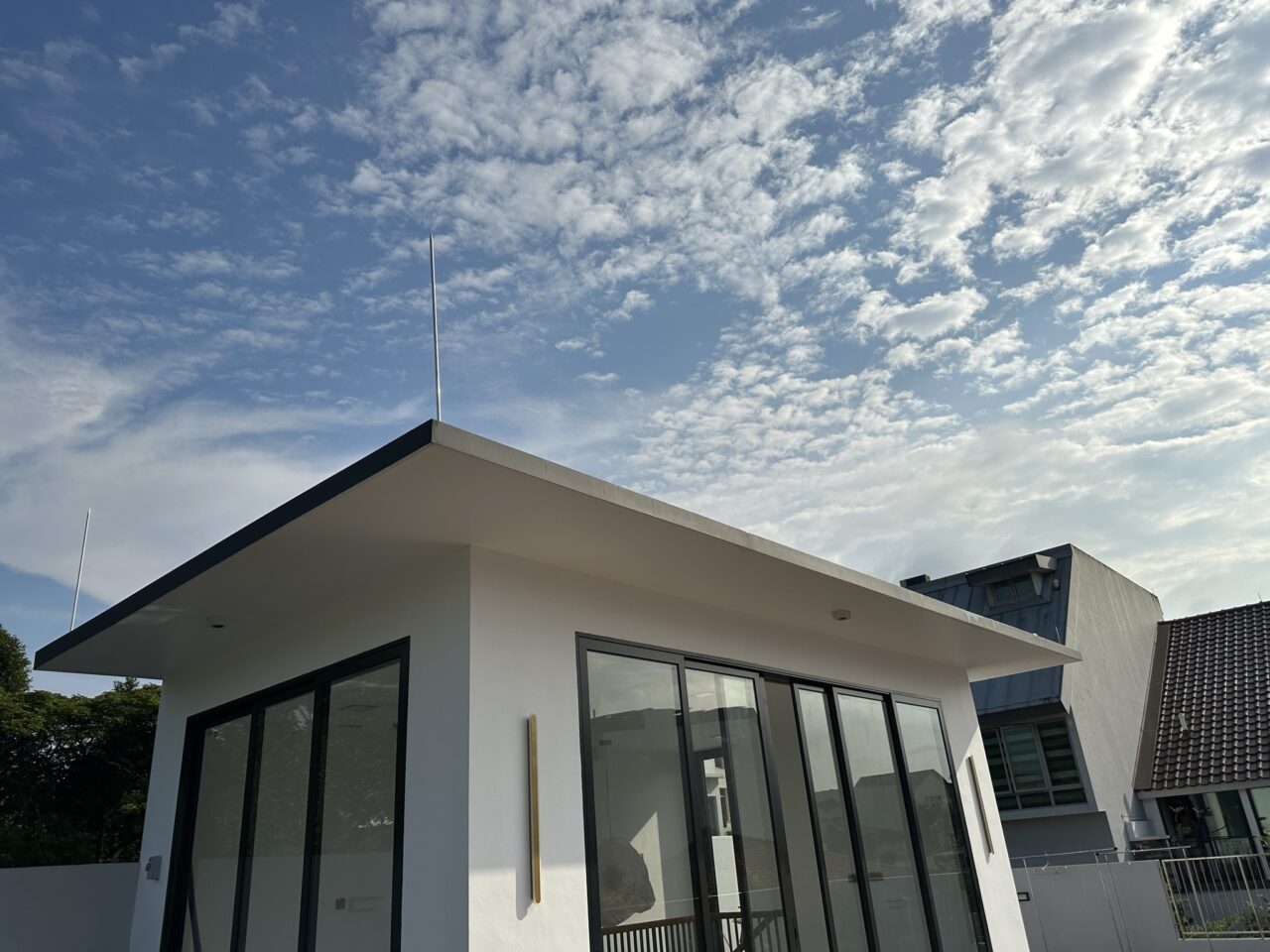 Modern building with large windows and blue sky.