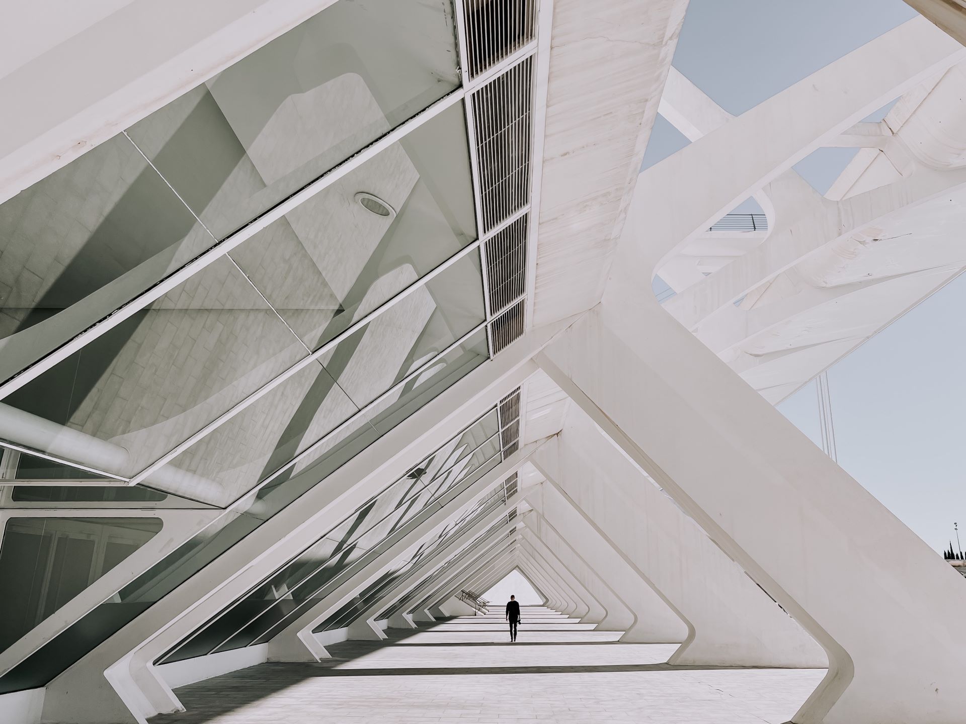 Modern architectural walkway with person walking.