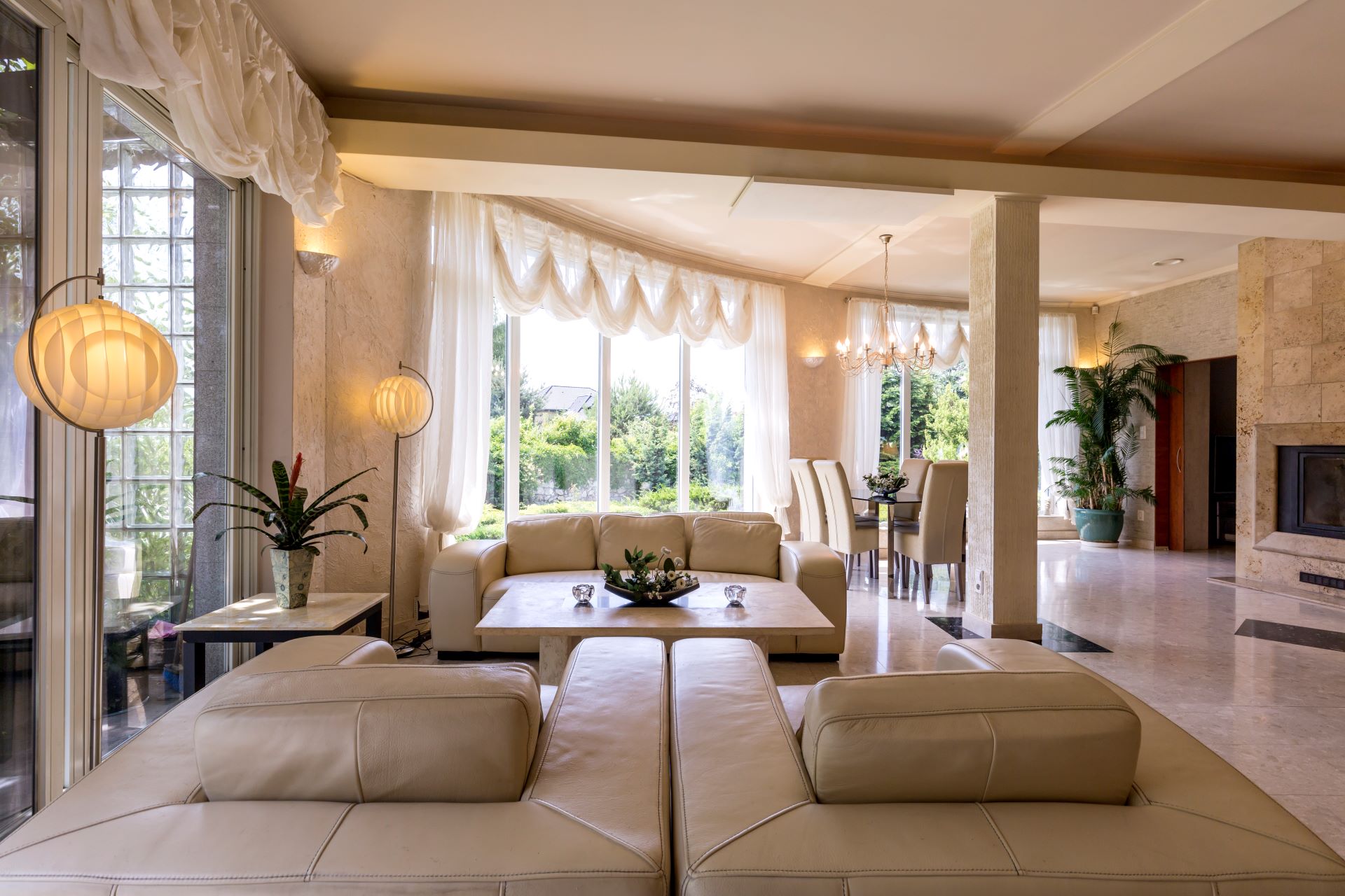 Modern living room with large windows and fireplace.